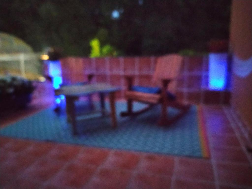 a table and two chairs on a patio at night at Estancia Edurne in Mungia