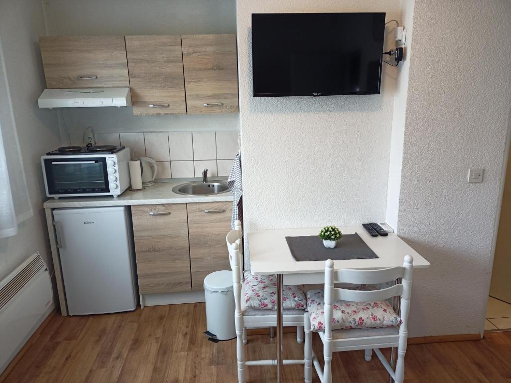eine kleine Küche mit einem kleinen Tisch und einer Mikrowelle in der Unterkunft Apartman 2 Zagreb - Maksimir KBC Rebro in Zagreb