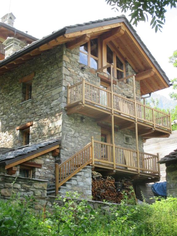 a house with wooden balconies on the side of it at Chalet Borney in Fontainamore
