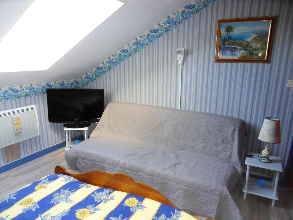 a bedroom with a bed and a flat screen tv at L Imperatrice in Berck-sur-Mer