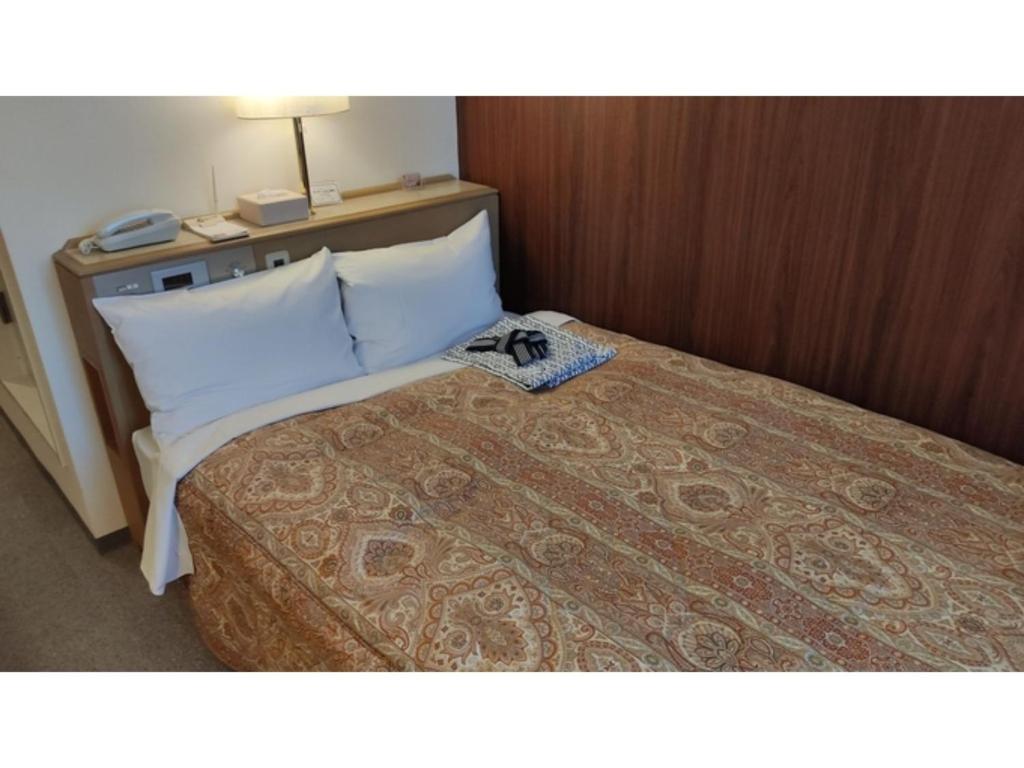 Säng eller sängar i ett rum på Central Hotel Toride - Vacation STAY 09921v