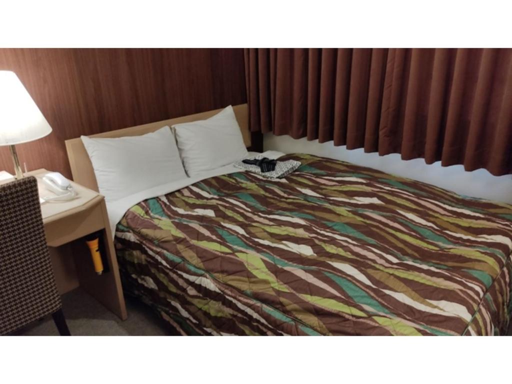 Un pat sau paturi într-o cameră la Central Hotel Toride - Vacation STAY 09932v