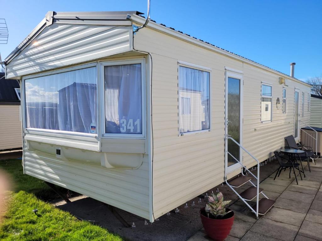 a white caravan with a door and windows at 341 Family Caravan at Marine Holiday Park, sleeps 6 in Rhyl