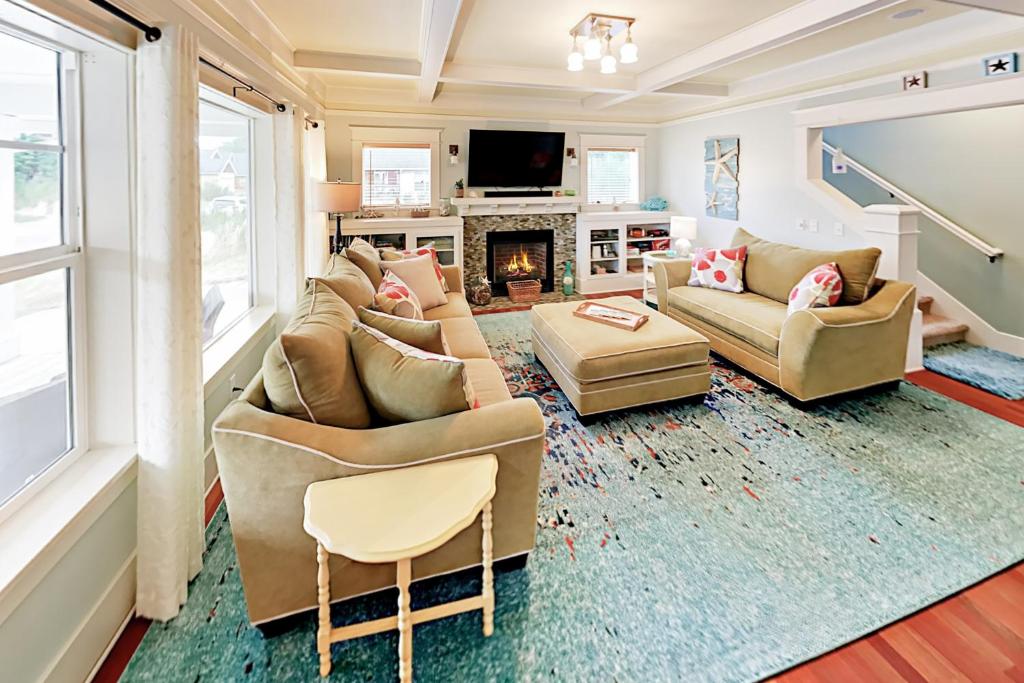 a living room with two couches and a fireplace at Rockin' Away Beach House in Rockaway Beach