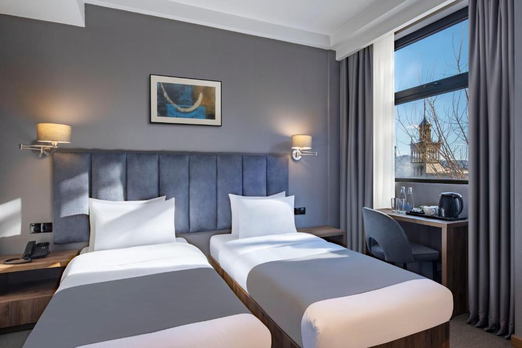 Postel nebo postele na pokoji v ubytování Barnovi Boutique Hotel