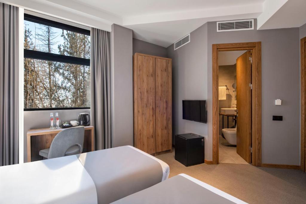 Postel nebo postele na pokoji v ubytování Barnovi Boutique Hotel