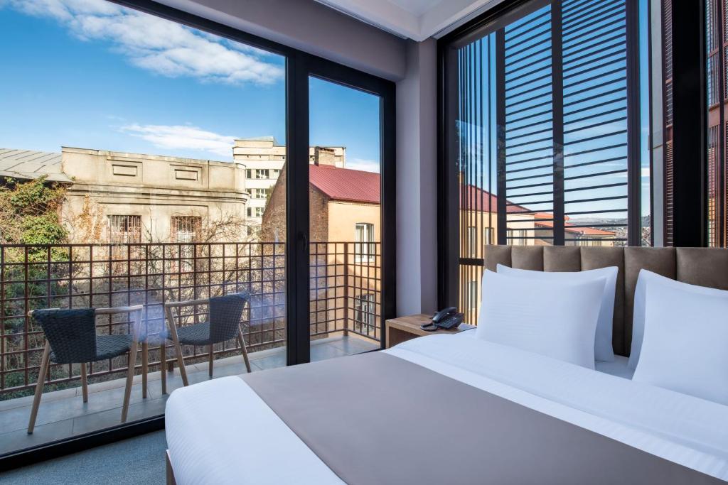 Postel nebo postele na pokoji v ubytování Barnovi Boutique Hotel