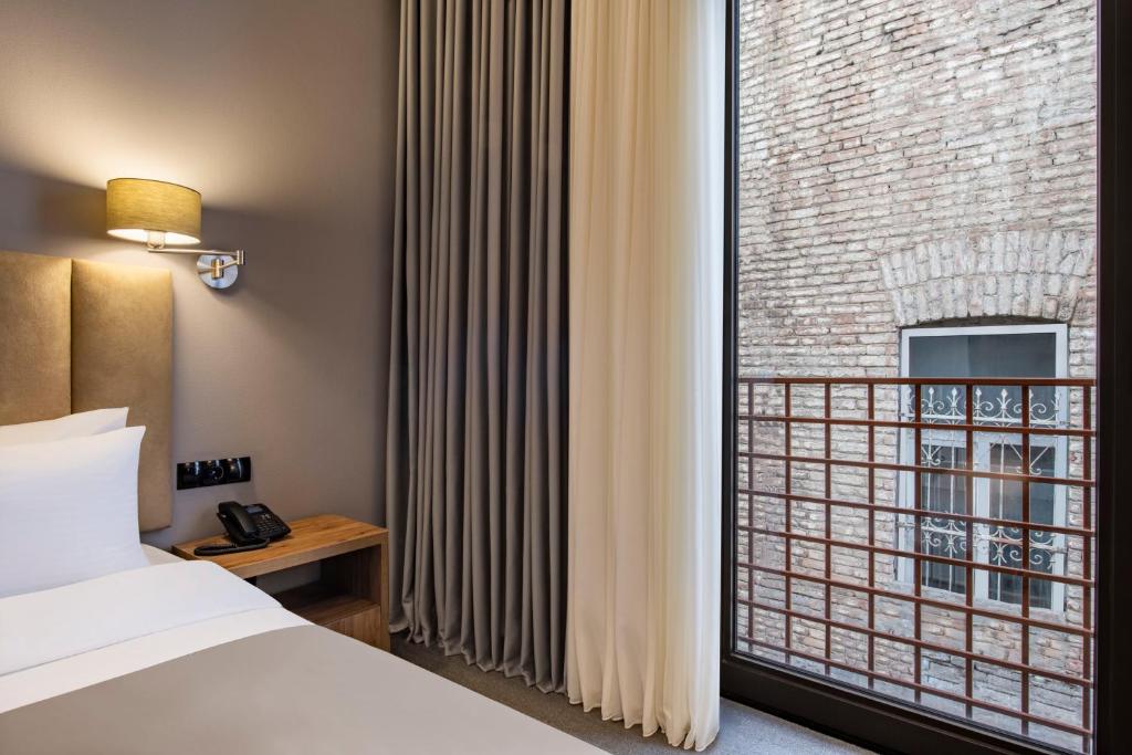 Postel nebo postele na pokoji v ubytování Barnovi Boutique Hotel