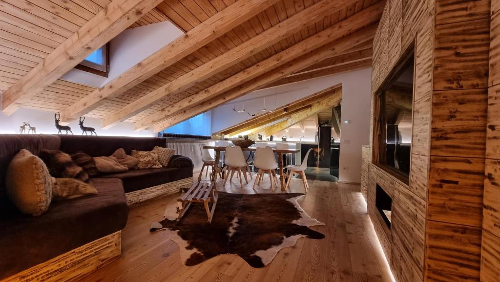 a living room with a couch and a table at Mansarda la Baita in Madonna di Campiglio