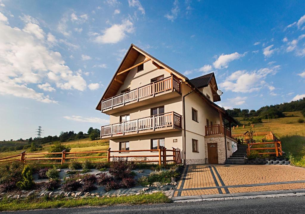 a house with a balcony on the side of it at Villa Apia in Piwniczna-Zdrój