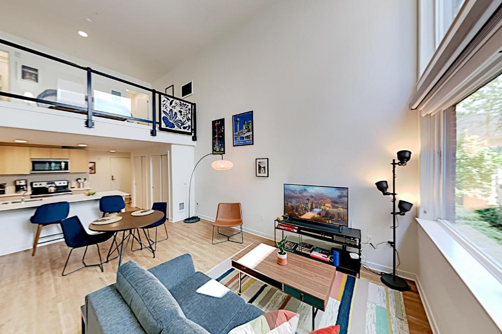 a living room with a couch and a table at Central Loft in Seattle