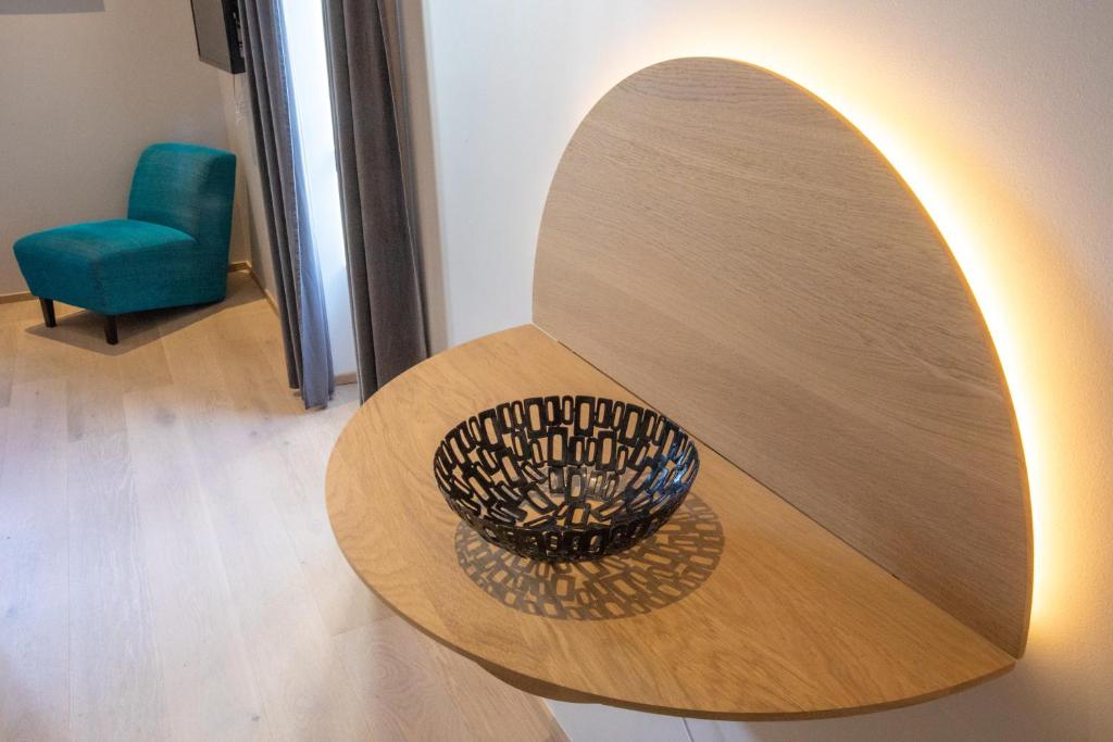 a wooden table with a bowl on top of it at Villa Saint Enogat in Aix-les-Bains