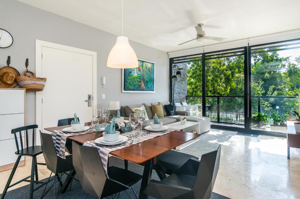 アクマルにあるLuxury Condo with Gym & BEACH Club & PGA golfのテーブルと椅子とソファのあるダイニングルーム