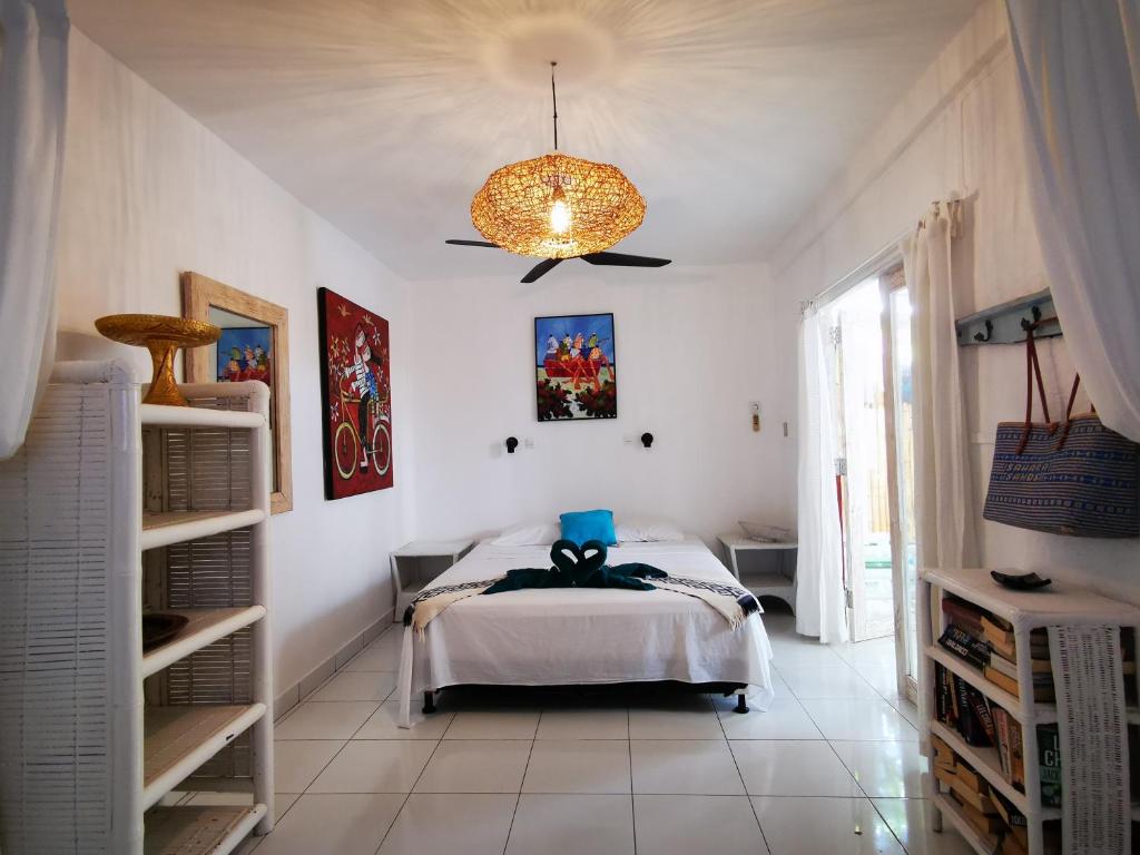 a bedroom with a bed and a chandelier at Sahara Sands Guest House - Gili Trawangan in Gili Trawangan