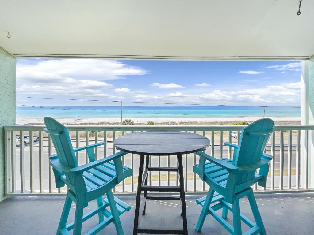 a table and chairs on a balcony with a view of the ocean at Laguna Lookout in Panama City Beach