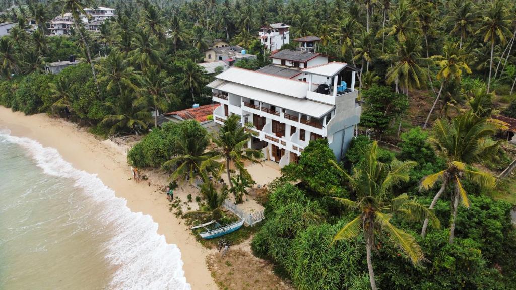 an aerial view of a building on the beach at La Polena in Matara
