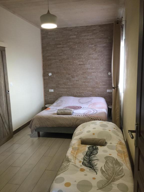 Postel nebo postele na pokoji v ubytování Ô cœur de l’île