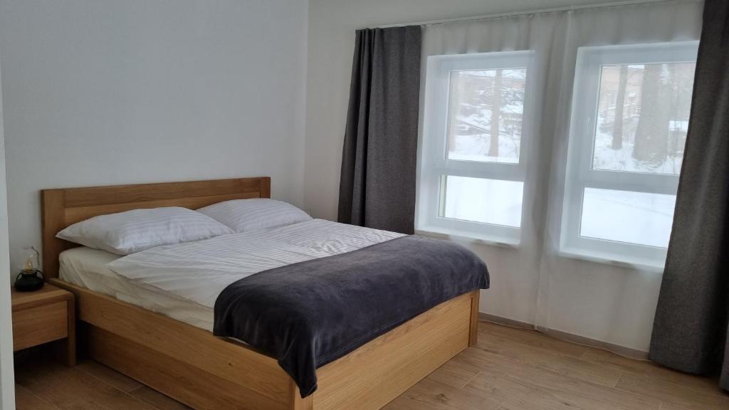 Postel nebo postele na pokoji v ubytování Apartmány Mlýnská