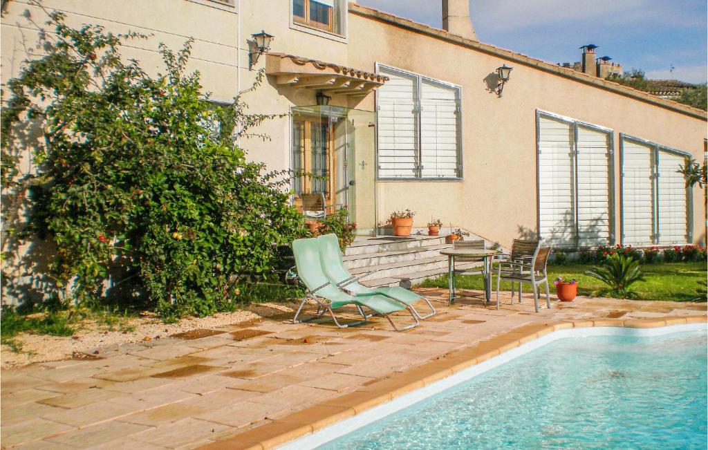 a patio with a table and chairs next to a pool at Lovely Home In Santa Cristina D'aro in Santa Cristina d'Aro