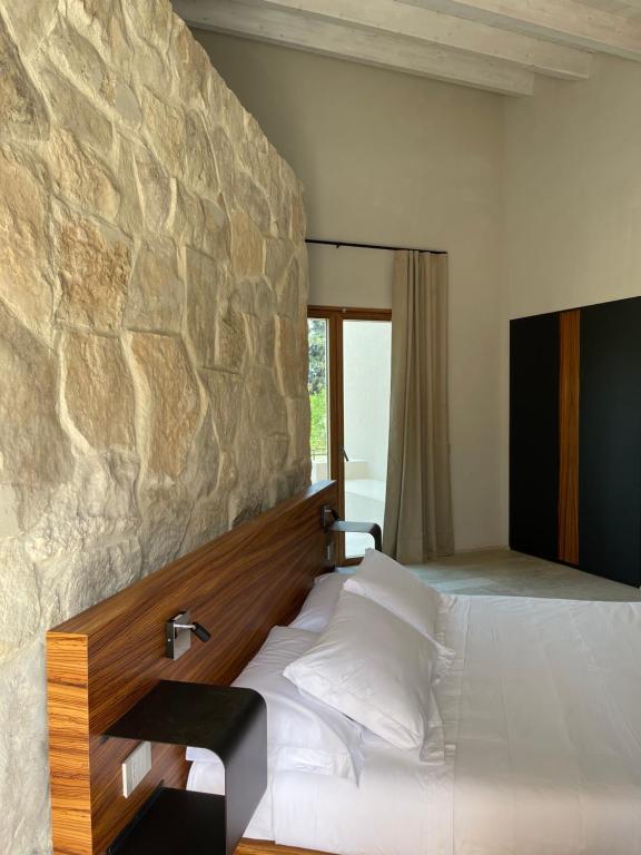Postel nebo postele na pokoji v ubytování Chiusa Di Carlo Agriturismo