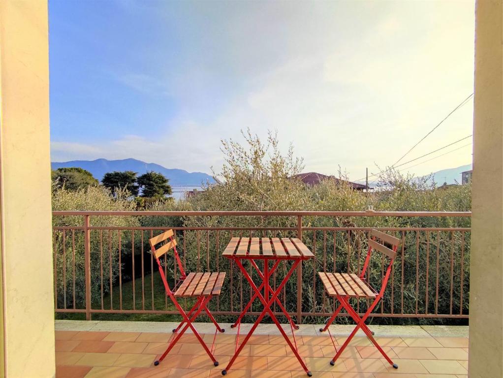 two chairs and a table on a balcony at IseoLakeRental - L'Uliveto di Bea in Predore