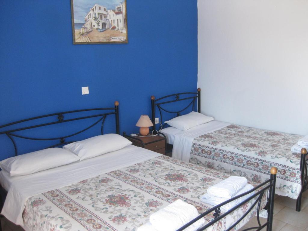 A bed or beds in a room at Calypso Hotel