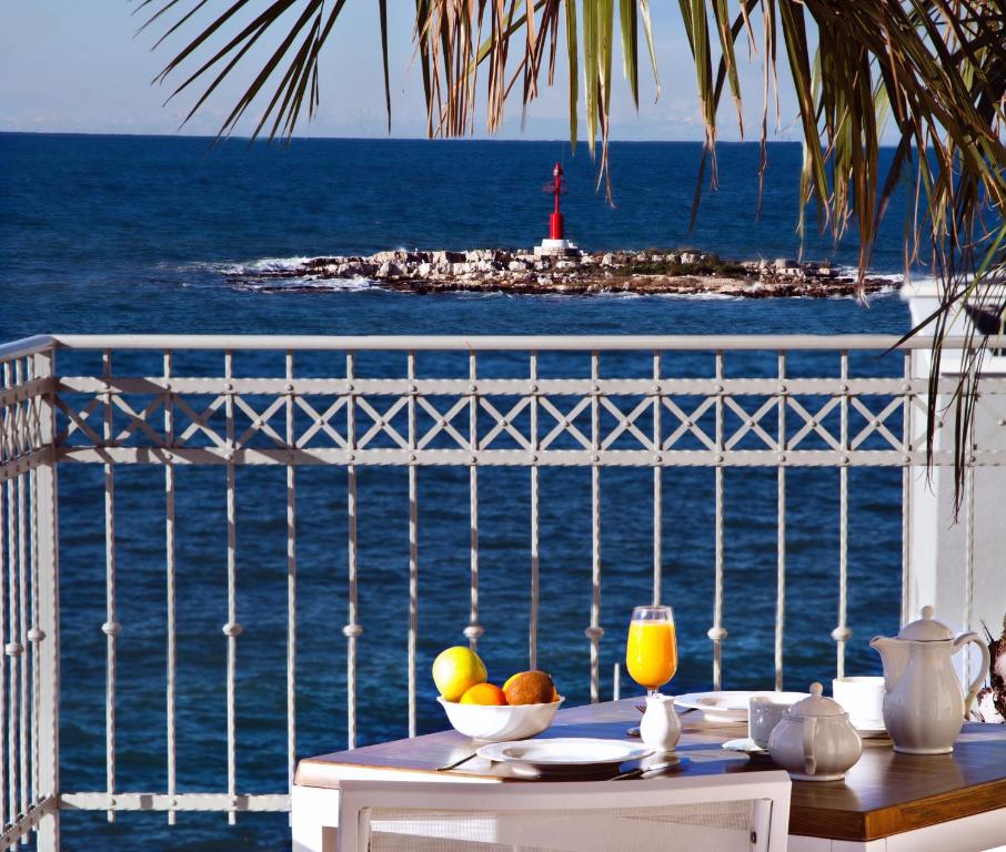 a table with a view of the ocean and a lighthouse at BO Hotel Palazzo in Poreč