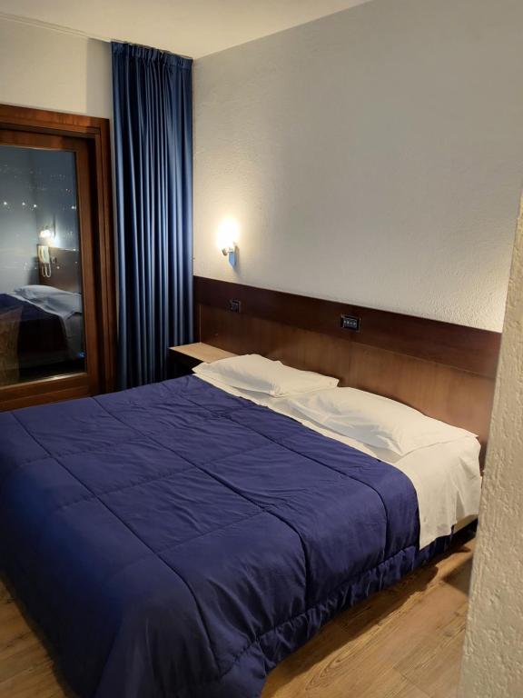 Uma cama ou camas num quarto em Hotel Miage