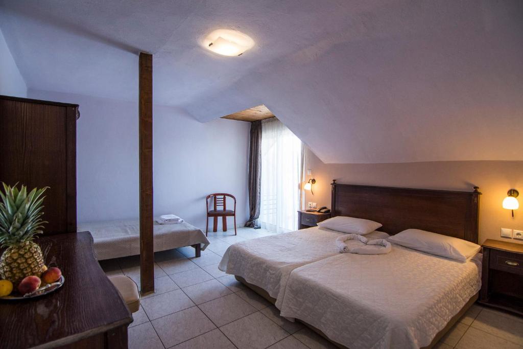 Postel nebo postele na pokoji v ubytování Rihios Hotel