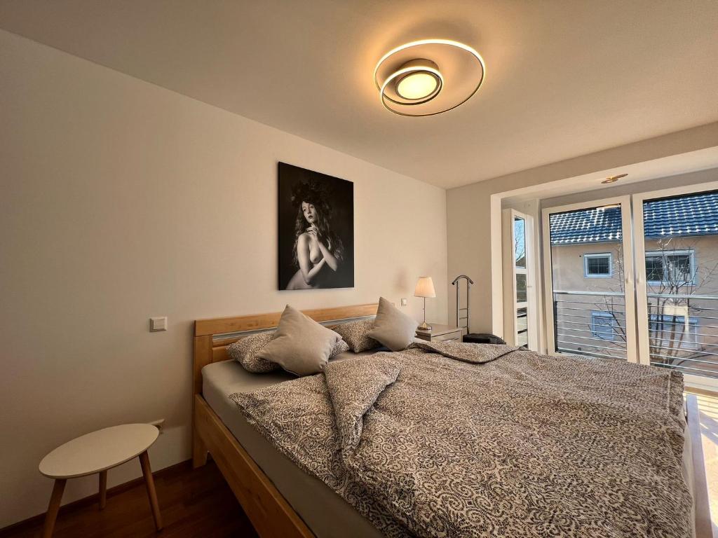 a bedroom with a large bed with a window at Sonnenschein in Stetten