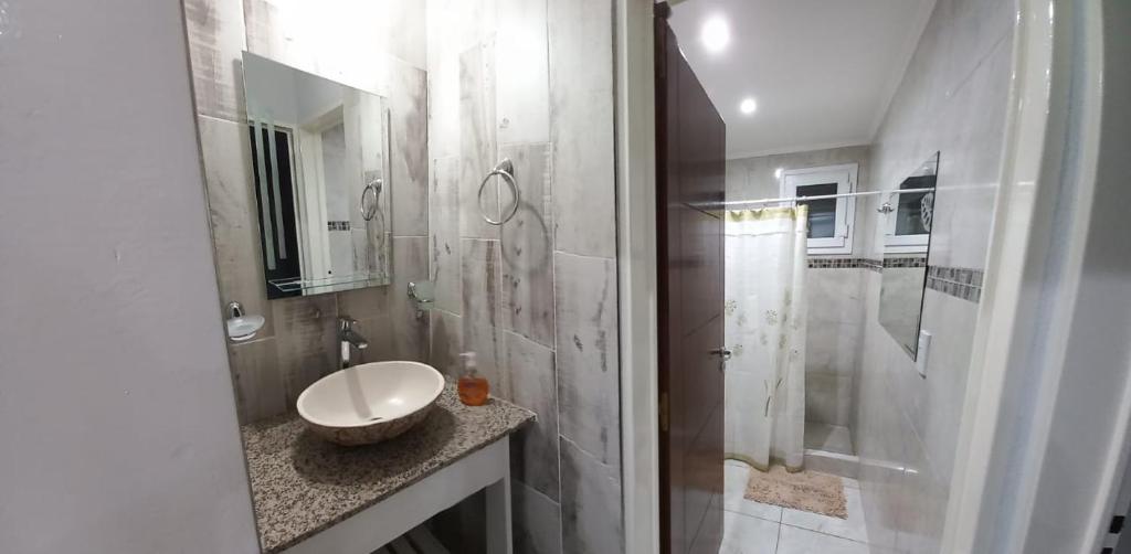 a white bathroom with a sink and a shower at Los 7 Deseos in Tandil