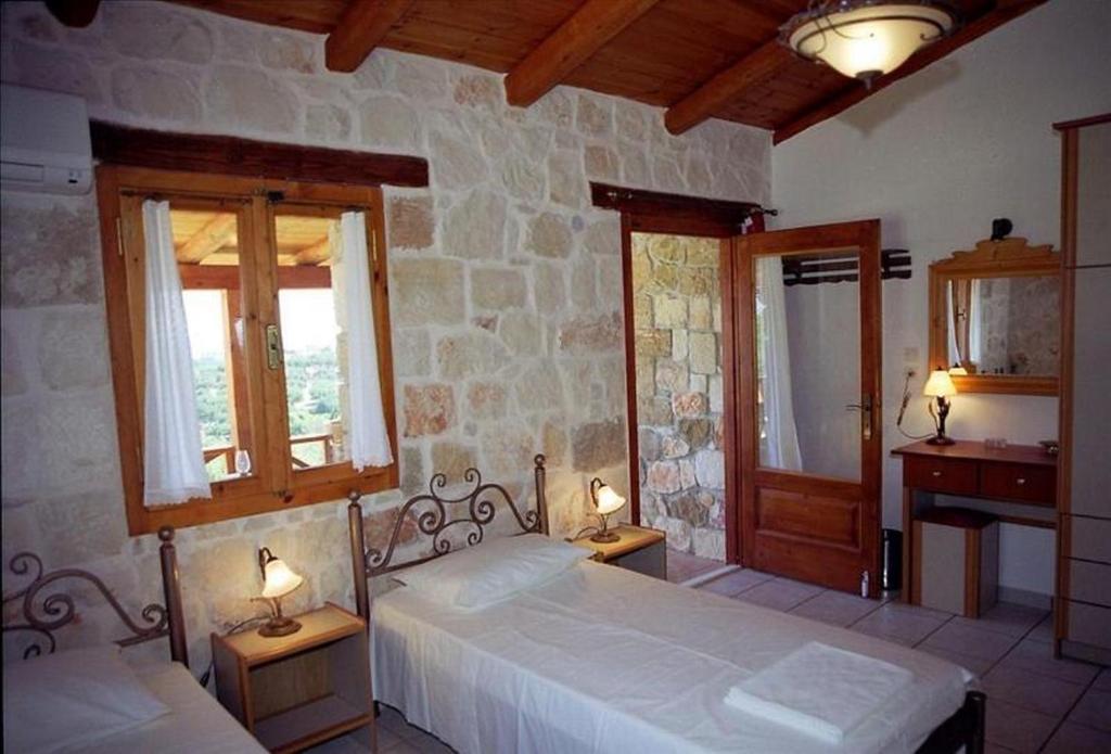 una camera con due letti e due finestre di Villa Belvedere - Best panoramic sea view apts a Vasilikós