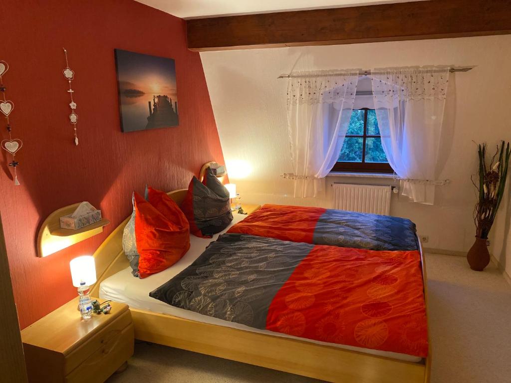 a bedroom with a large bed and a window at Froeschlein 2 - no Gitters & craftsman in Ilmenau