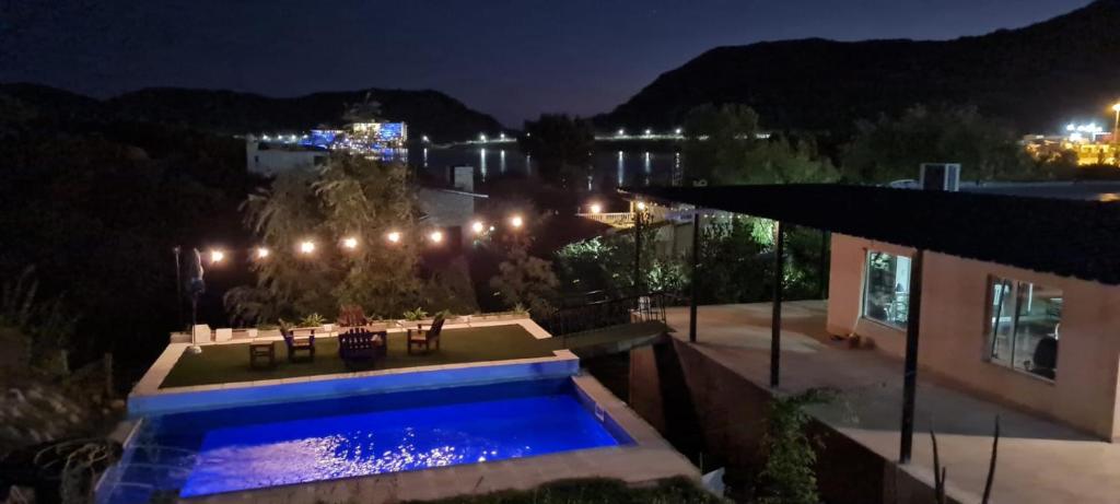 a house with a swimming pool at night at La Colina - Potrero de los Funes in Potrero de los Funes