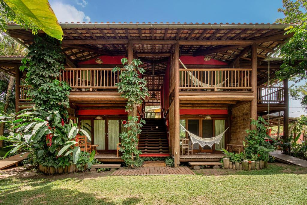 a house with a hammock on the front of it at Solar Pitanga - Taipu de Fora in Barra Grande