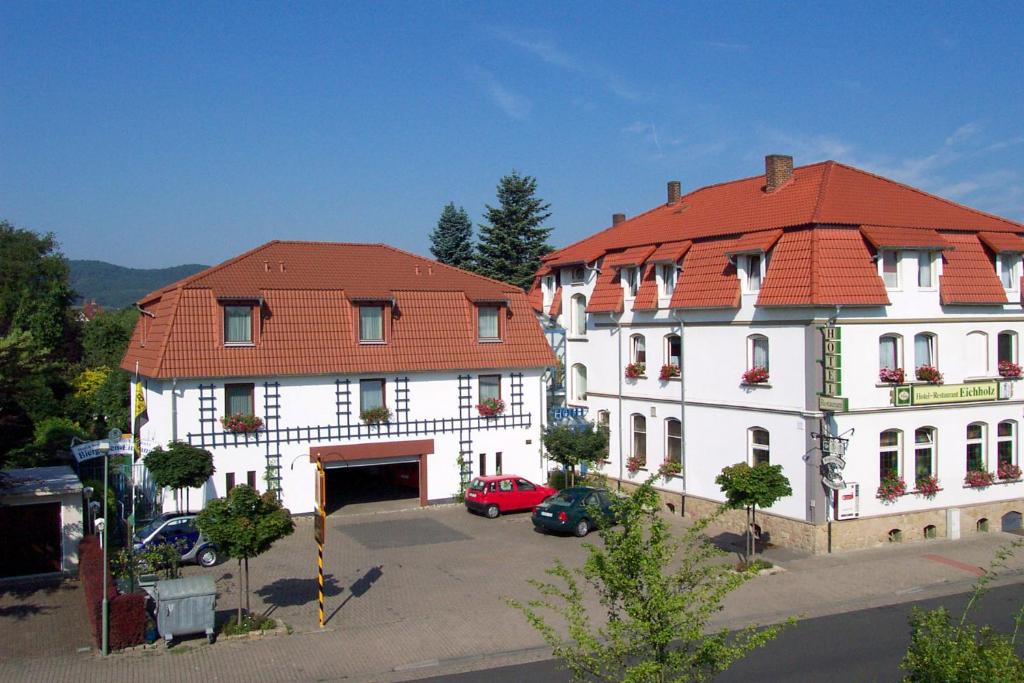 un gran edificio blanco con techo rojo en Hotel & Restaurant Eichholz en Kassel