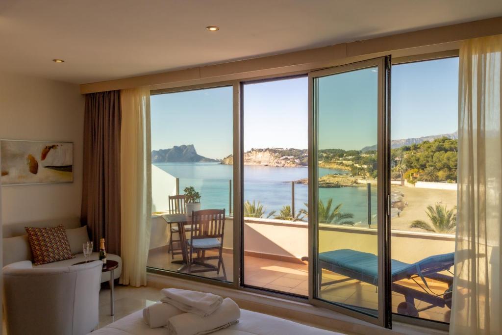 
a hotel room with a view of the ocean at La Sort Boutique Hotel in Moraira

