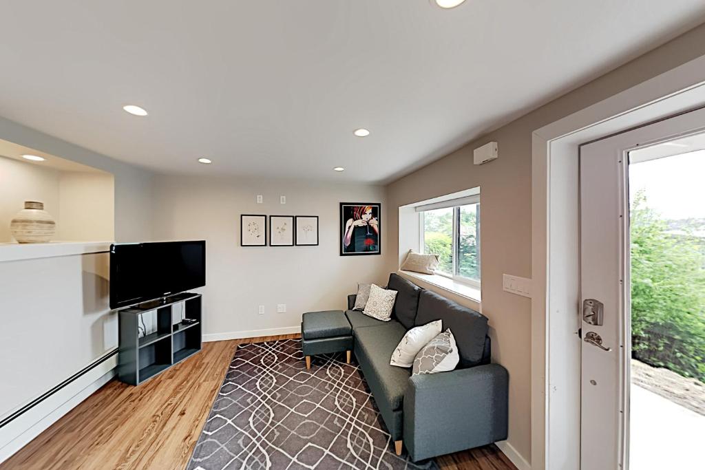 a living room with a couch and a tv at Queen Anne Escape in Seattle