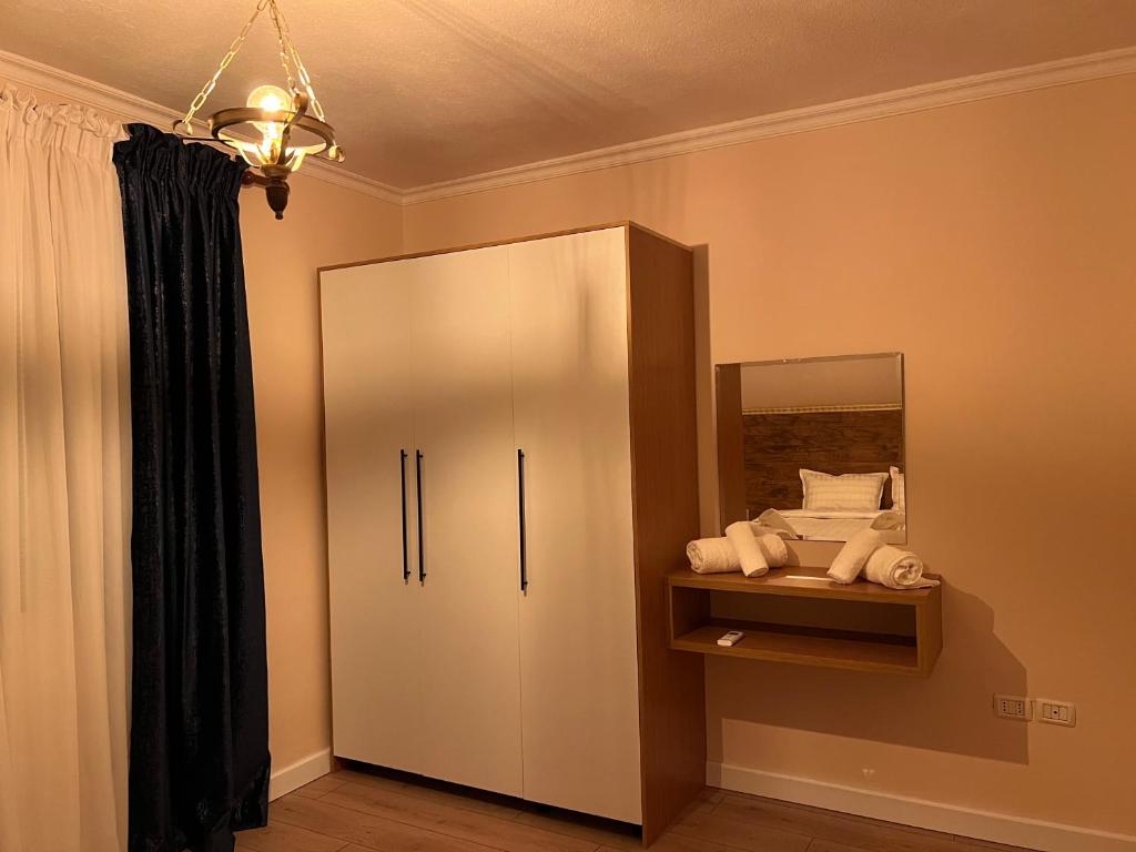 a bathroom with a medicine cabinet with a mirror at Chestnut Yard Villa in Tirana