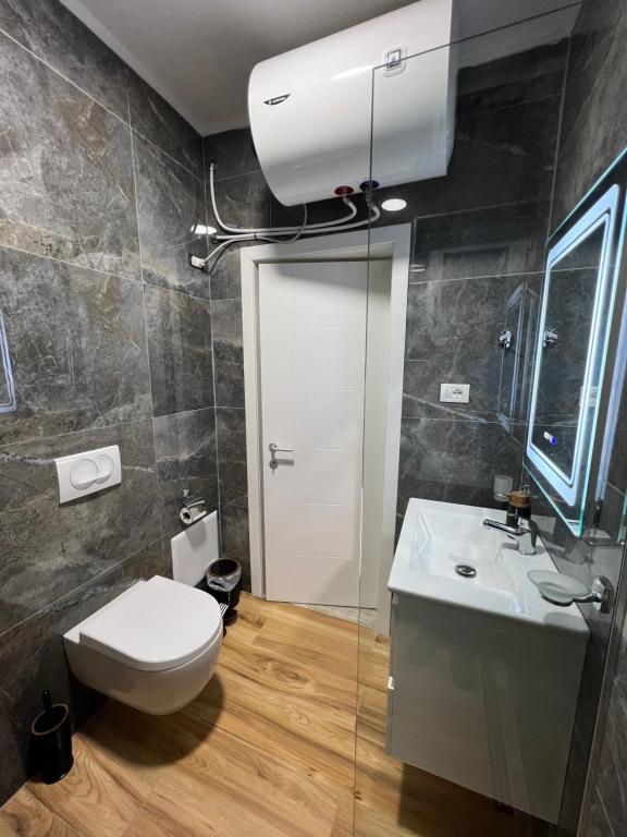 a bathroom with a toilet and a sink at Chestnut Yard Villa in Tirana
