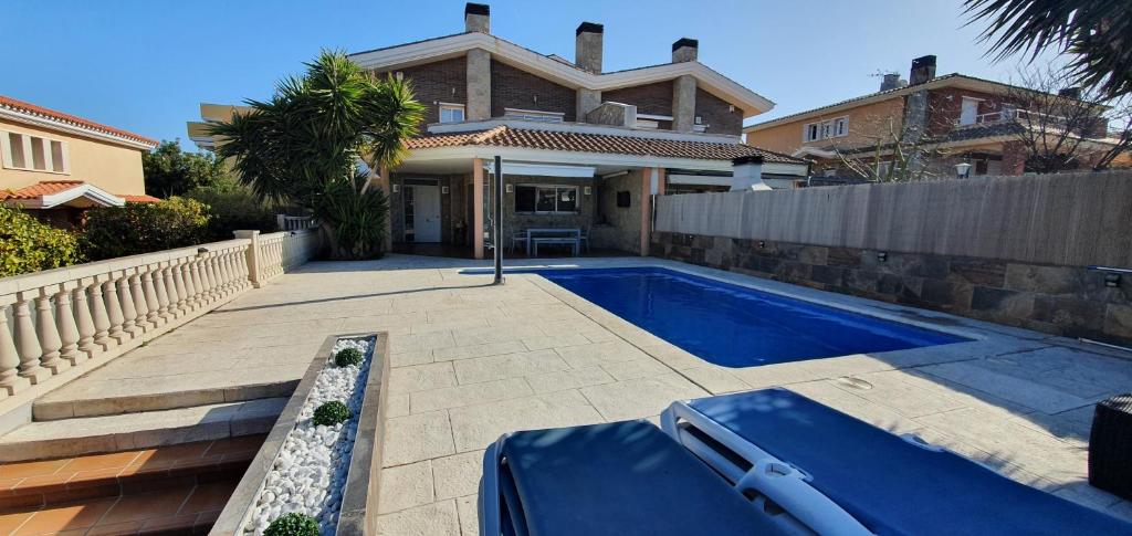 a swimming pool in front of a house at Villa castelló salou in Salou