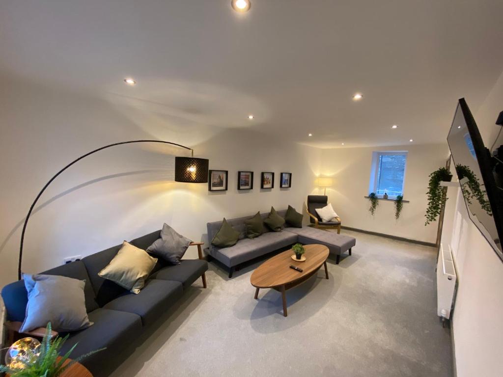 a living room with a couch and a table at Spacious City Centre Property in Lancaster