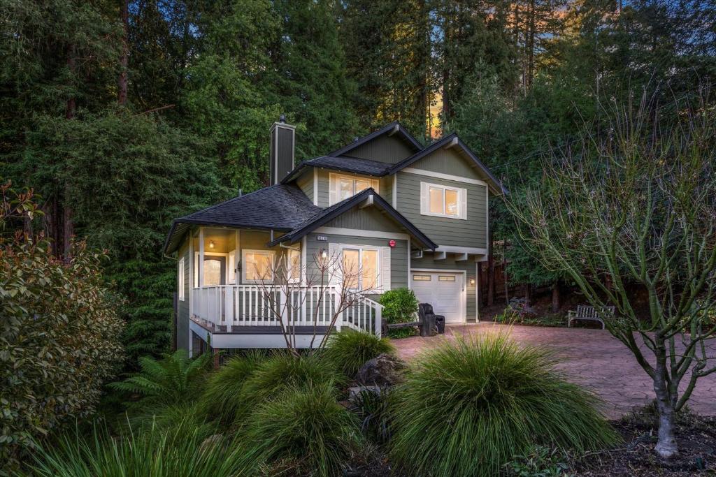 a small house in the middle of a forest at Lazy Bear Lodge Hot Tub Dog Friendly BBQ Grill Forest Views in Guerneville