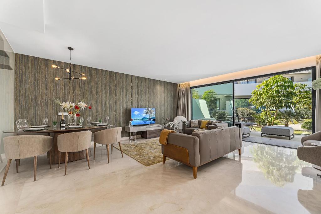 a living room with a table and a dining room at Oasis by the Sea in La Cala de Mijas (La Valvega) in Mijas Costa