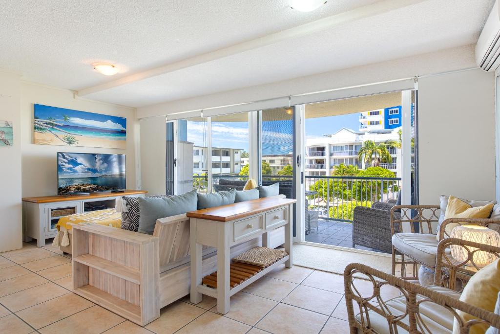 a living room with a couch and a table at Coral Sea Apartments in Maroochydore