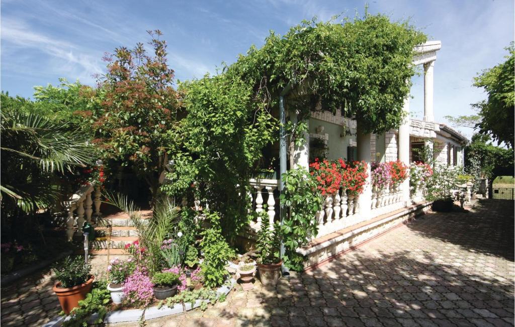 a house with a white fence and lots of flowers at Awesome Apartment In Medulin With Wifi in Medulin