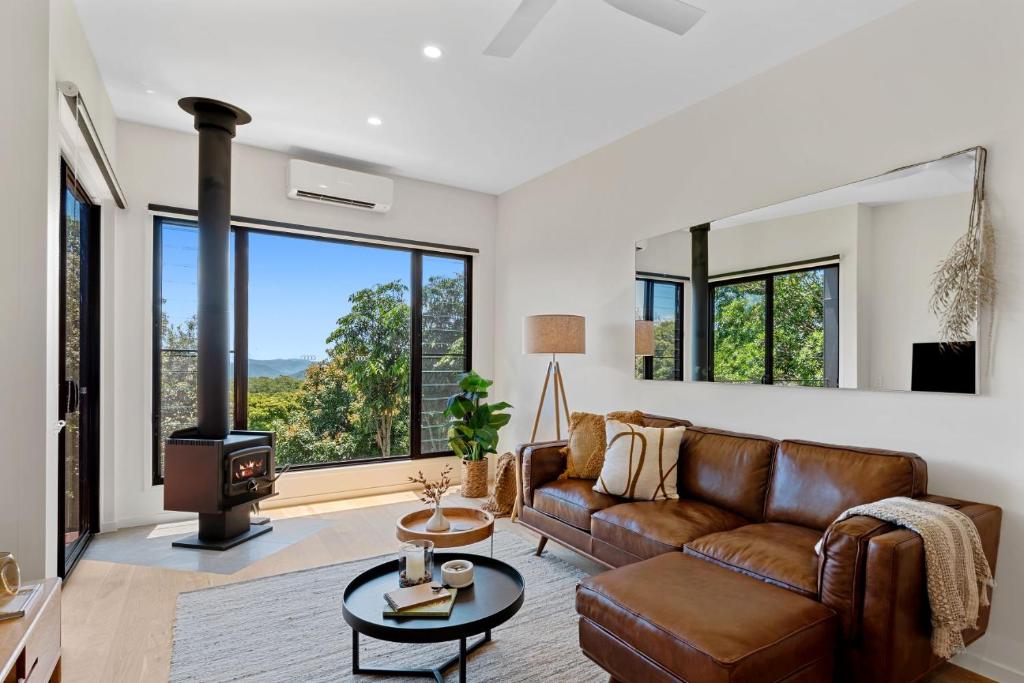 a living room with a couch and a wood stove at The Ridge at Maleny 1 Bedroom Villa in Maleny