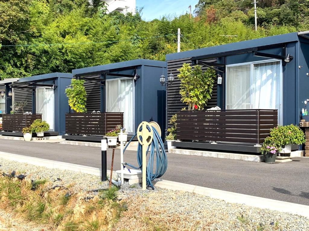 a row of mobile homes on the side of a road at Sparky’s House in Naoshima