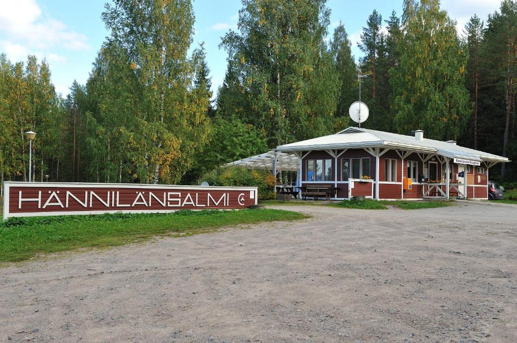 a small building with a sign in front of it at Hännilänsalmi Camping in Viitasaari