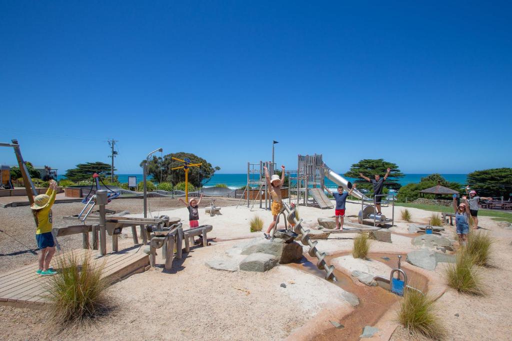 a group of children playing in a playground at BIG4 Apollo Bay Pisces Holiday Park in Apollo Bay